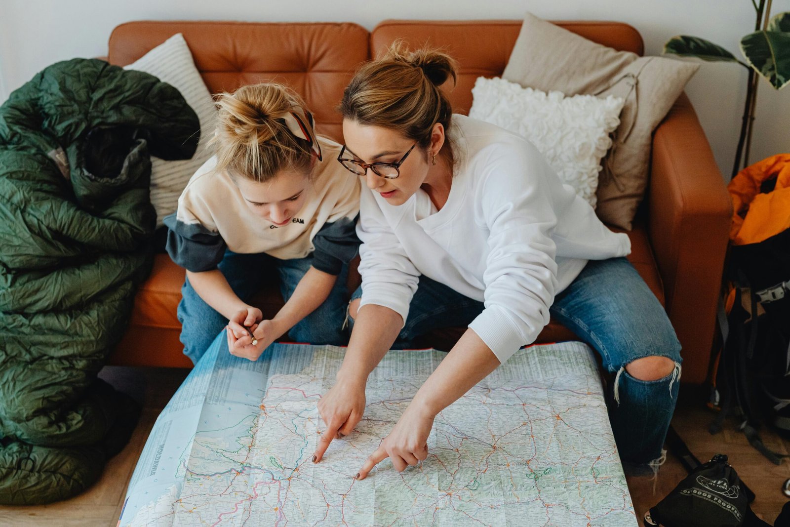 A dedicated Disney travel agent smiling while meticulously planning a family's dream vacation, showcasing maps, a laptop, and the excitement of a personalized magical trip.