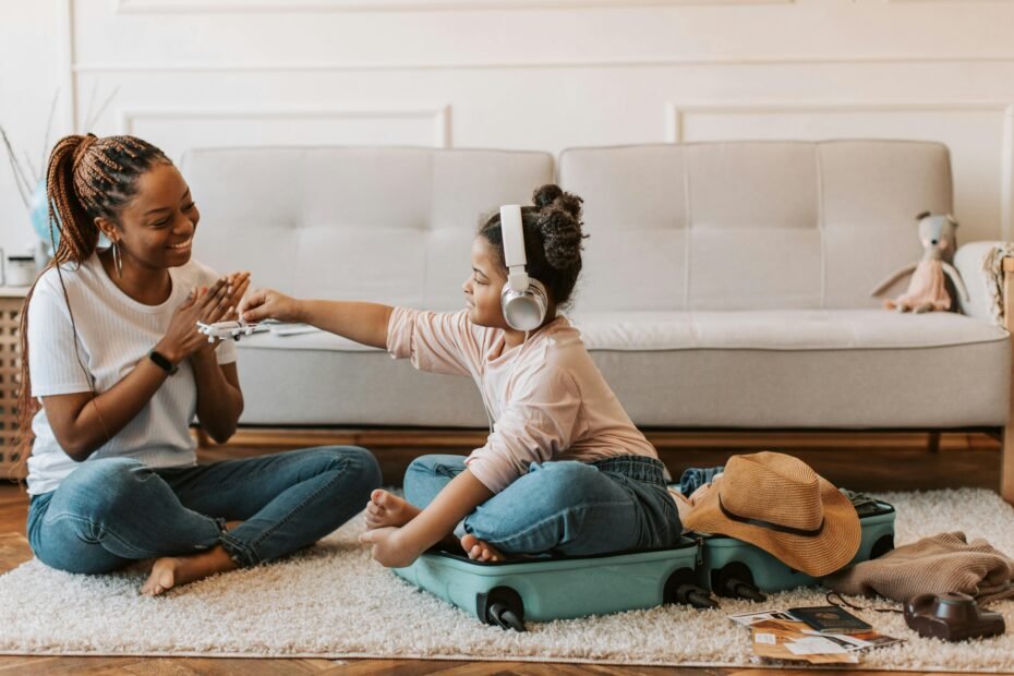Happy children playing portable travel games with their family during a long journey, illustrating engaging entertainment for kids and quality family time.
