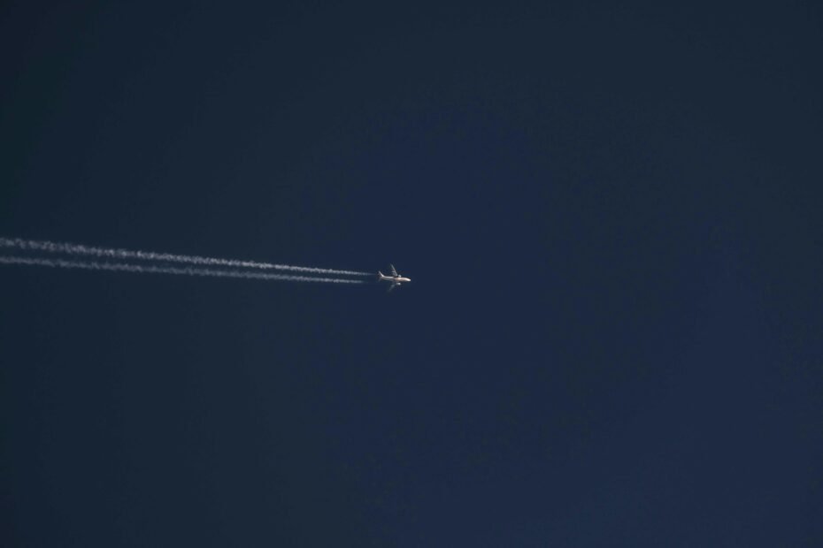 A modern commercial jet airplane flying at high cruising speed above the clouds, illustrating the impressive speeds of air travel and the efficiency of various aircraft types.