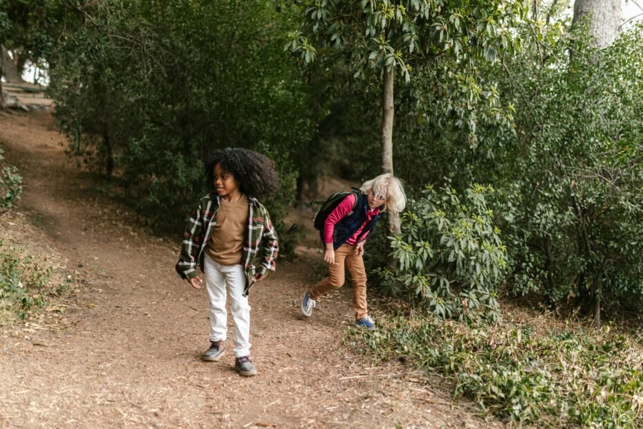 Happy young child confidently carrying a colorful kids travel backpack at an airport, symbolizing independence and comfortable family travel.