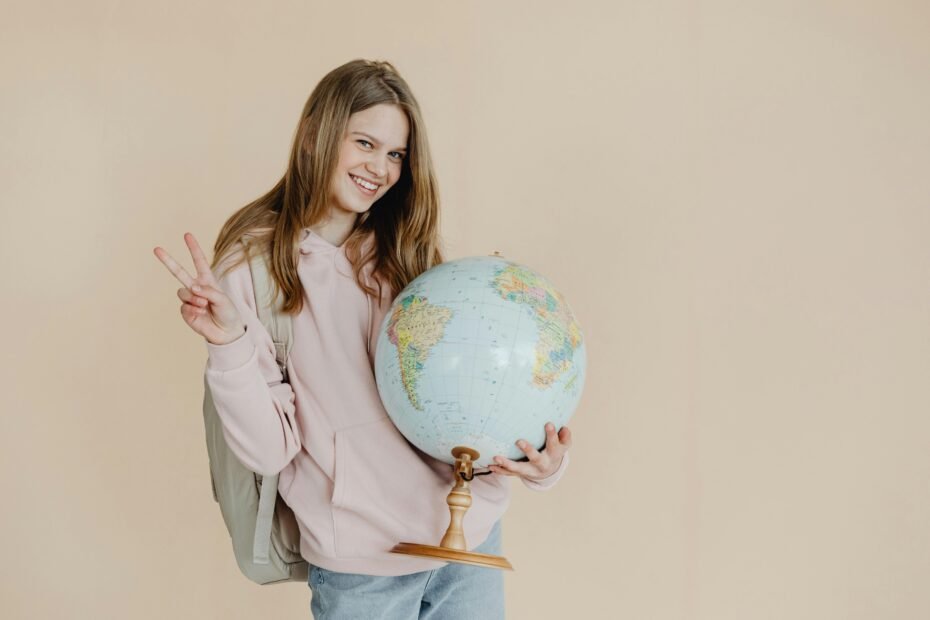 Young person with backpack and world map, symbolizing accessible travel jobs without experience and the dream of working abroad.