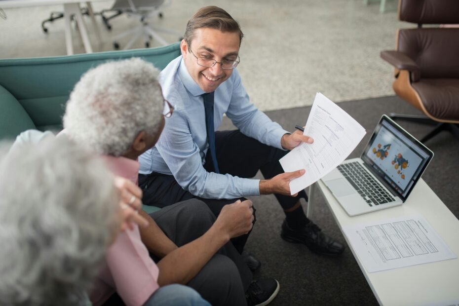 A Liberty Travel agent smiling and consulting a happy couple about their dream vacation, symbolizing personalized service and the ease of finding a local travel expert near you.