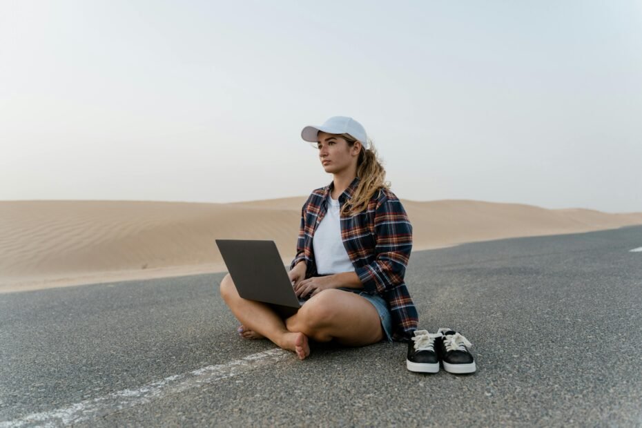 Illustrative image of a digital nomad working on a laptop from a beautiful travel destination, embodying remote work freedom and adventure travel careers.