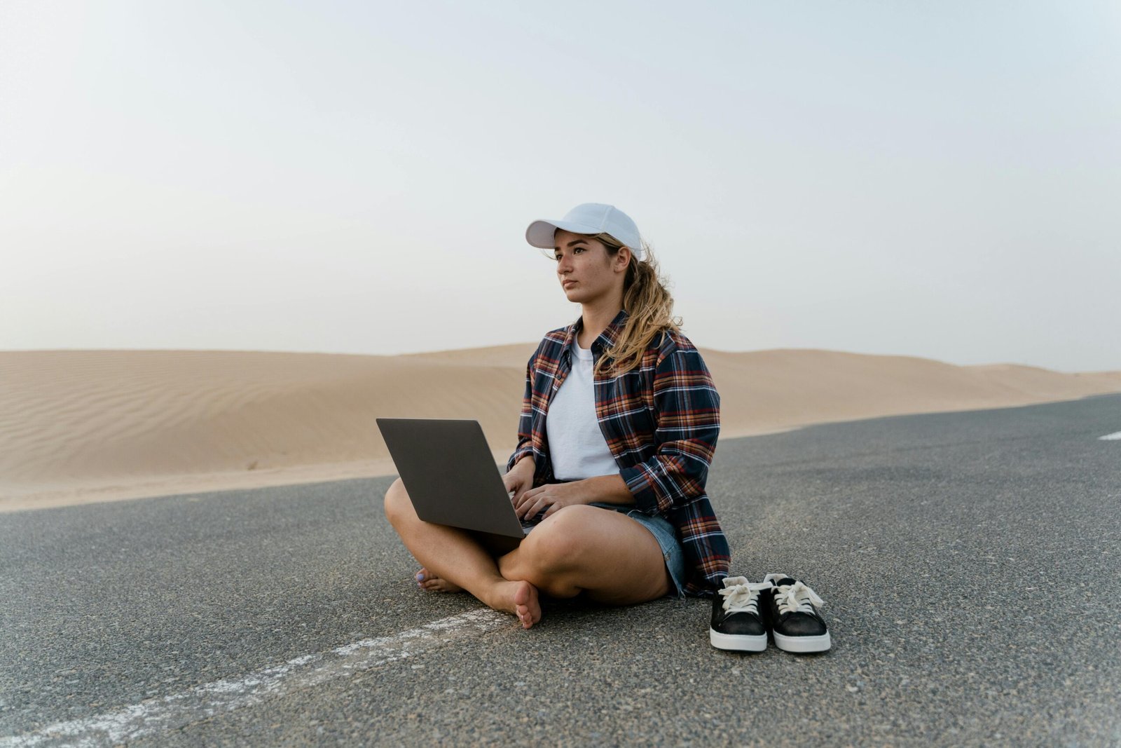 Illustrative image of a digital nomad working on a laptop from a beautiful travel destination, embodying remote work freedom and adventure travel careers.
