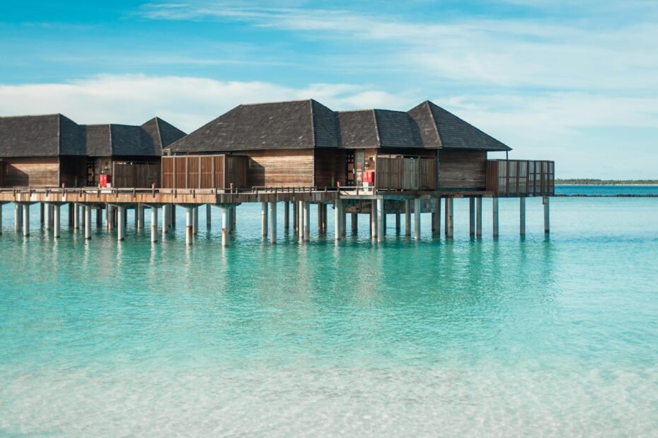 Breathtaking view of luxury overwater bungalows in the Maldives surrounded by clear turquoise waters, perfect for all-inclusive travel packages and a dream vacation.