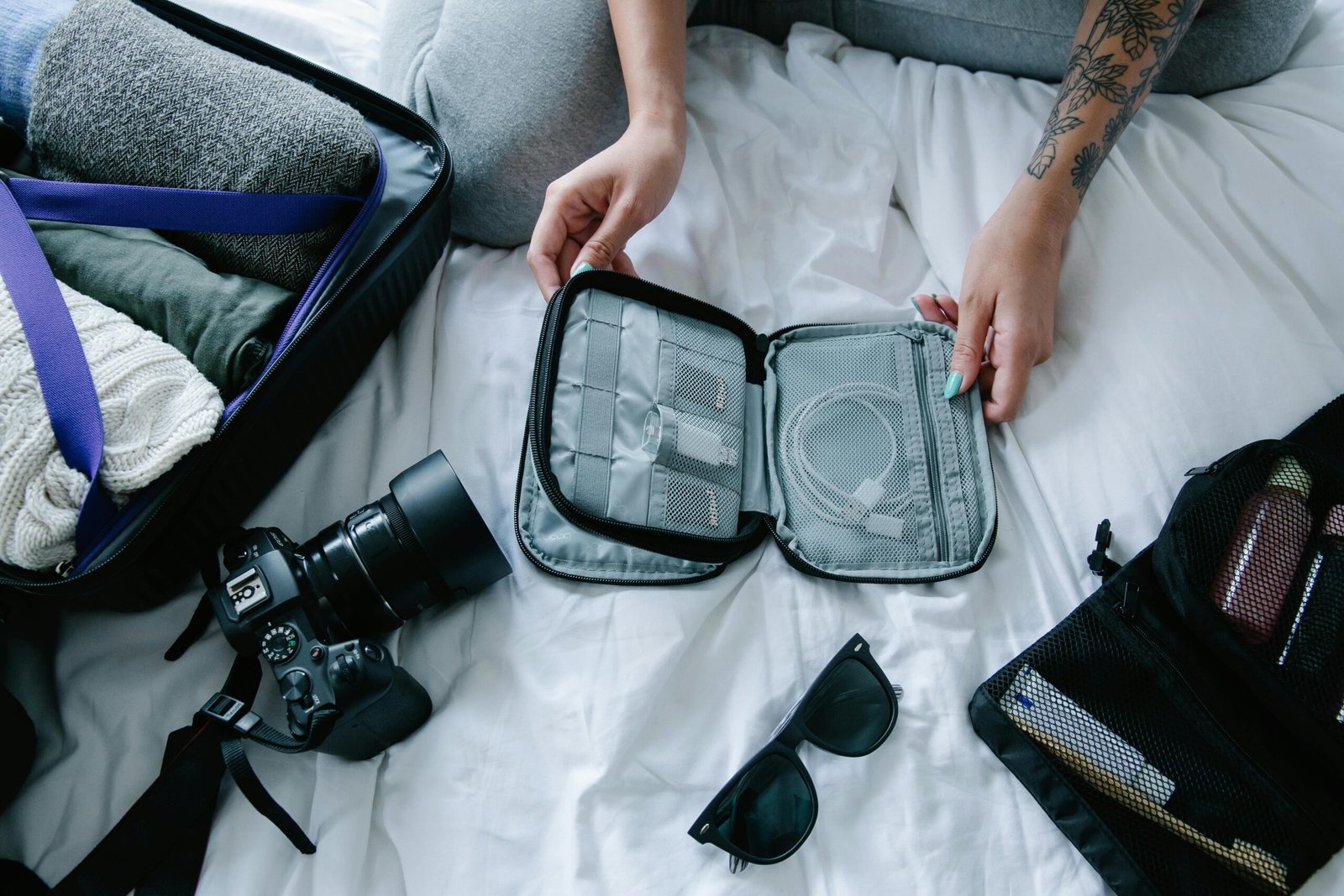 A neatly organized travel kit displaying essential items like travel-sized toiletries, tech accessories, and basic first-aid supplies, all packed for efficient and stress-free travel.