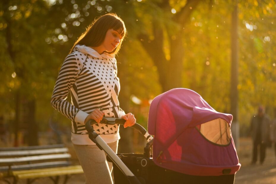 A parent comfortably pushing a baby in a versatile travel system stroller with an infant car seat attached, illustrating the convenience and safety of Baby Trend's all-in-one solution for newborns and active families.