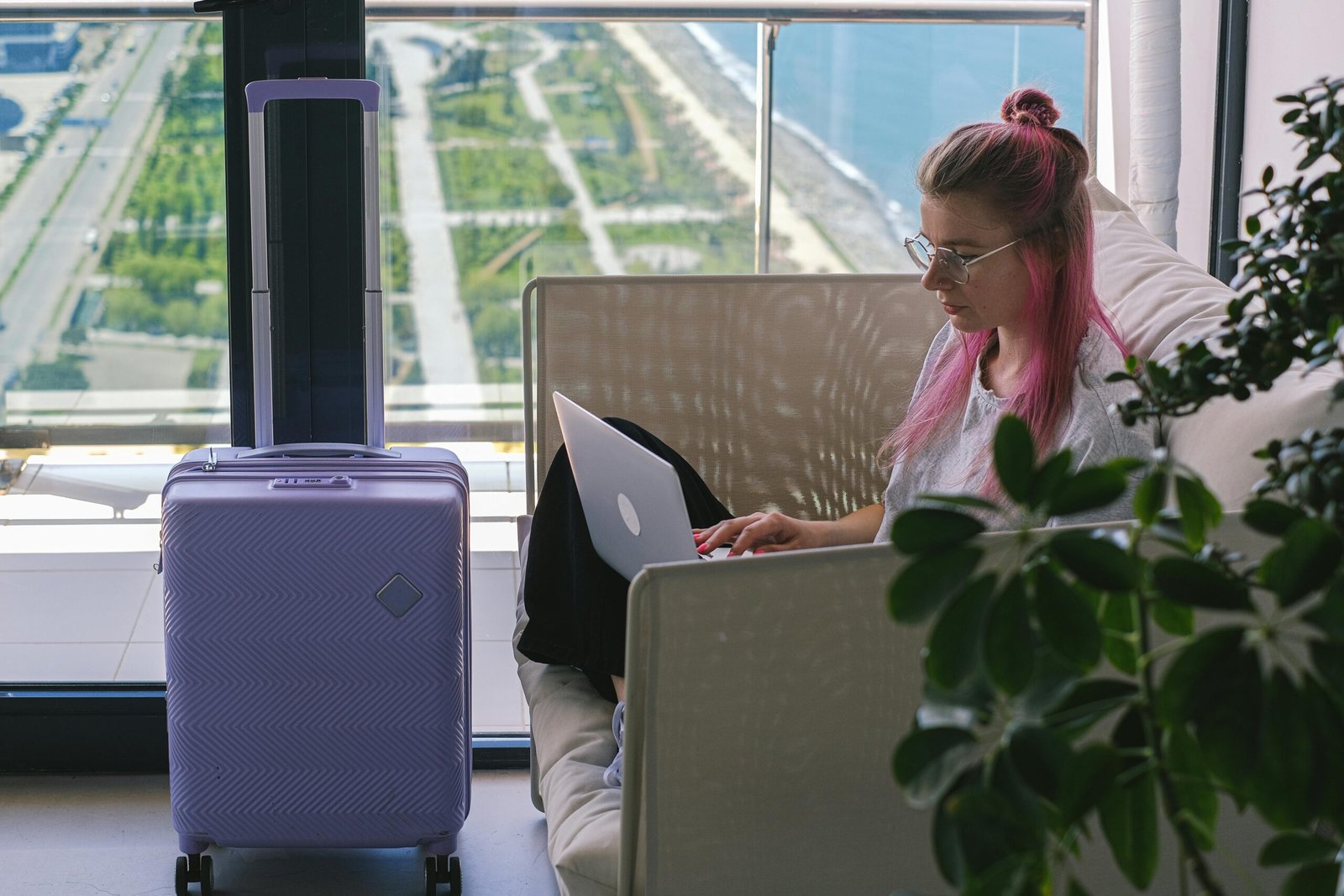 Professional travel agent using DeltaVacations.com on a computer to book comprehensive vacation packages, including flights, hotels, and car rentals, maximizing client value and agent commissions.