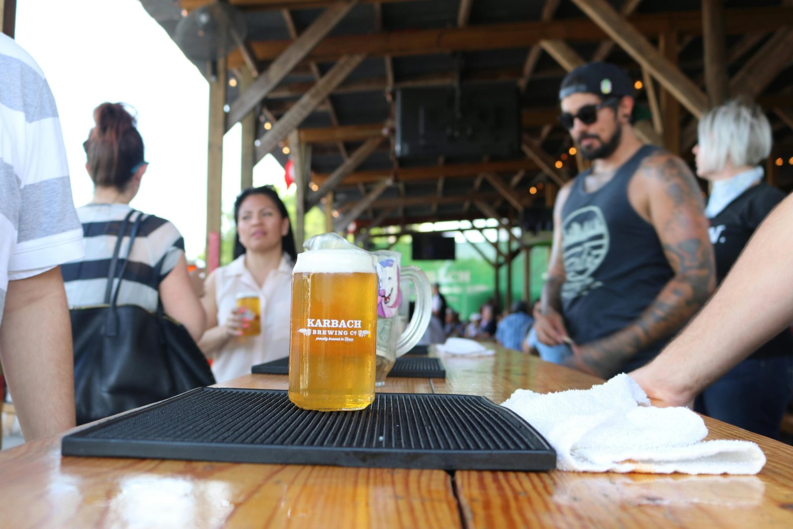 Happy travelers enjoying a craft beer tasting flight at a local brewery, embodying the 'traveling hoppy' adventure and discovery of brewing traditions.