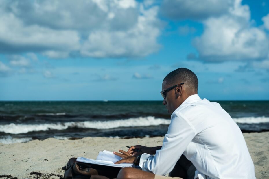 Professional travel agent working on a laptop with a Florida beach background, symbolizing the career path to becoming a successful travel advisor in the Sunshine State, including SOT registration.