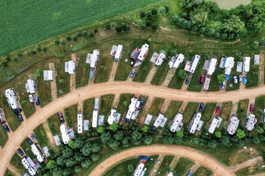 Shady Acres Travel Park featuring modern RVs on spacious, tree-lined sites, with guests enjoying the welcoming community and natural surroundings, emphasizing comfort and top-tier amenities for a memorable stay.