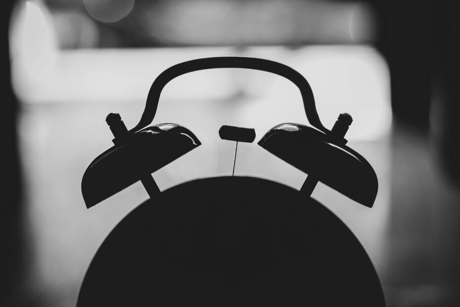 A reliable and compact travel alarm clock displayed with packed luggage and a passport, emphasizing stress-free and timely wake-ups for international travel.