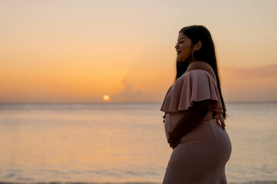 Happy pregnant woman traveling safely and peacefully on her babymoon, secured by specialist travel insurance for expectant mothers.
