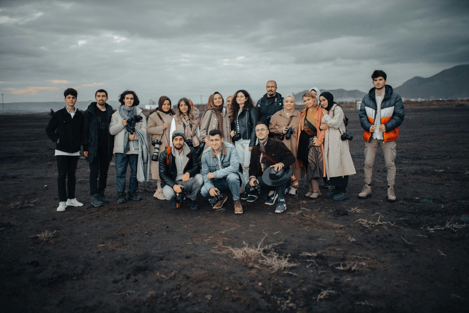 Diverse team members collaborating and celebrating success during a corporate retreat, highlighting the benefits of team member travel for improved collaboration and employee morale.