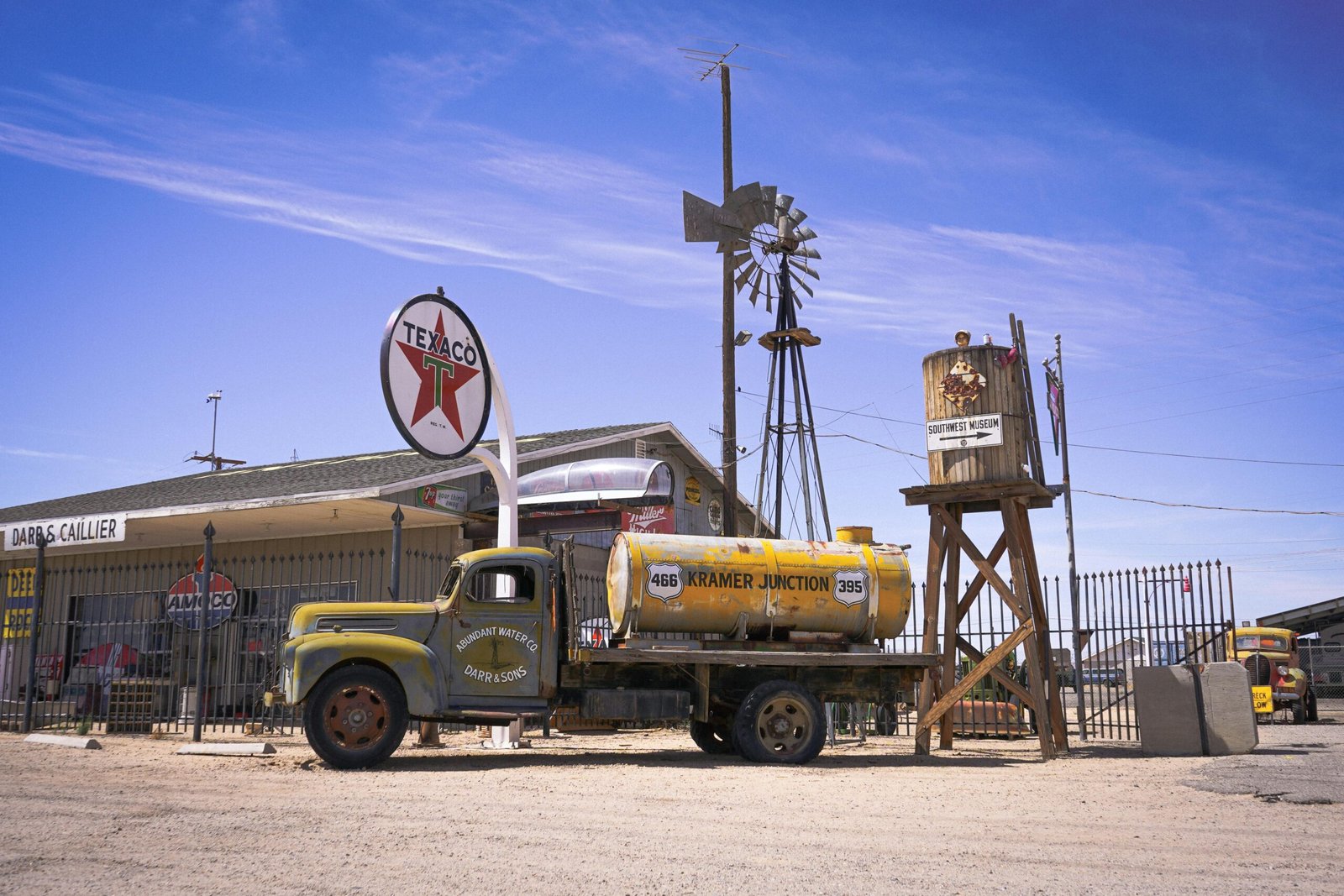 Rolling Hills Travel Center on I-5 in Northern California, featuring modern gas pumps, various vehicles including RVs and trucks, and comprehensive amenities for travelers.
