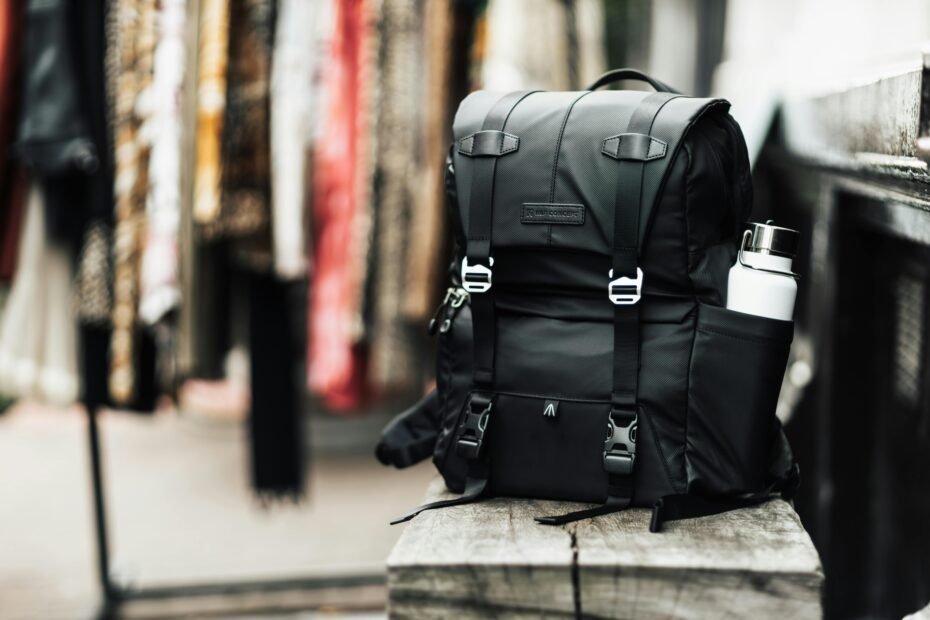 Modern traveler effortlessly rolling a versatile black travel bag backpack with wheels through a bright airport terminal, emphasizing the convenience and adaptability of this hybrid luggage for effortless mobility and stress-free travel.