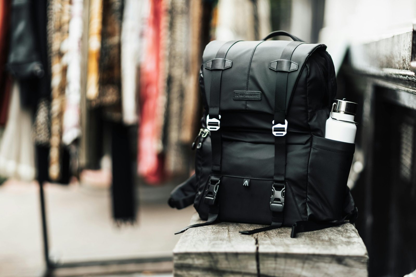 Modern traveler effortlessly rolling a versatile black travel bag backpack with wheels through a bright airport terminal, emphasizing the convenience and adaptability of this hybrid luggage for effortless mobility and stress-free travel.