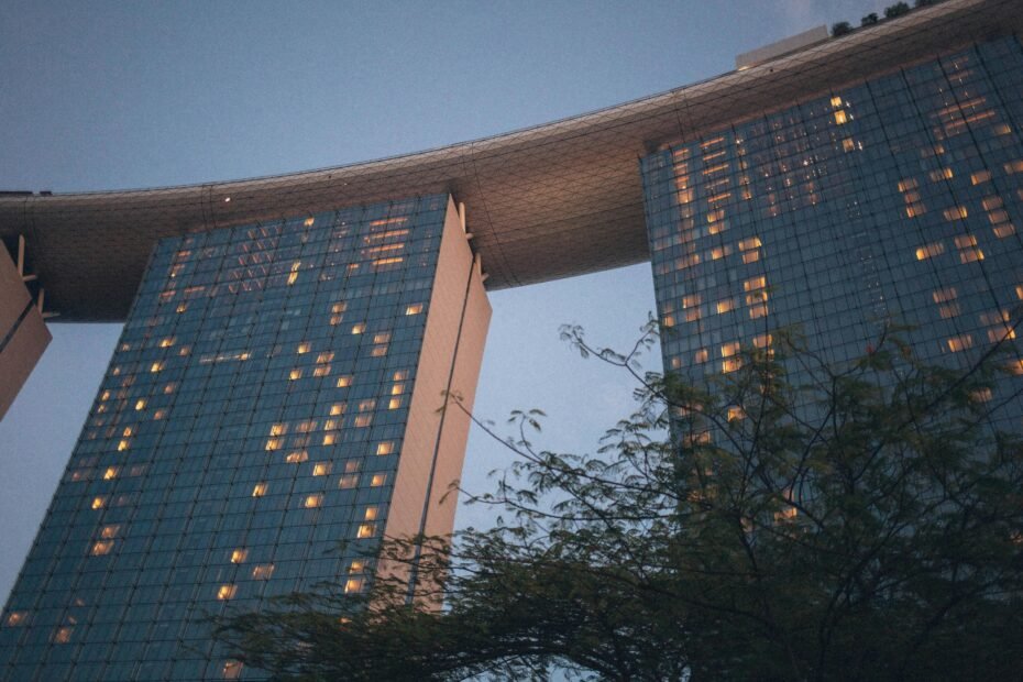Stunning panoramic view of Gardens by the Bay and Marina Bay Sands in Singapore on a bright, sunny day, illustrating the best time to travel to this tropical destination for outdoor exploration.