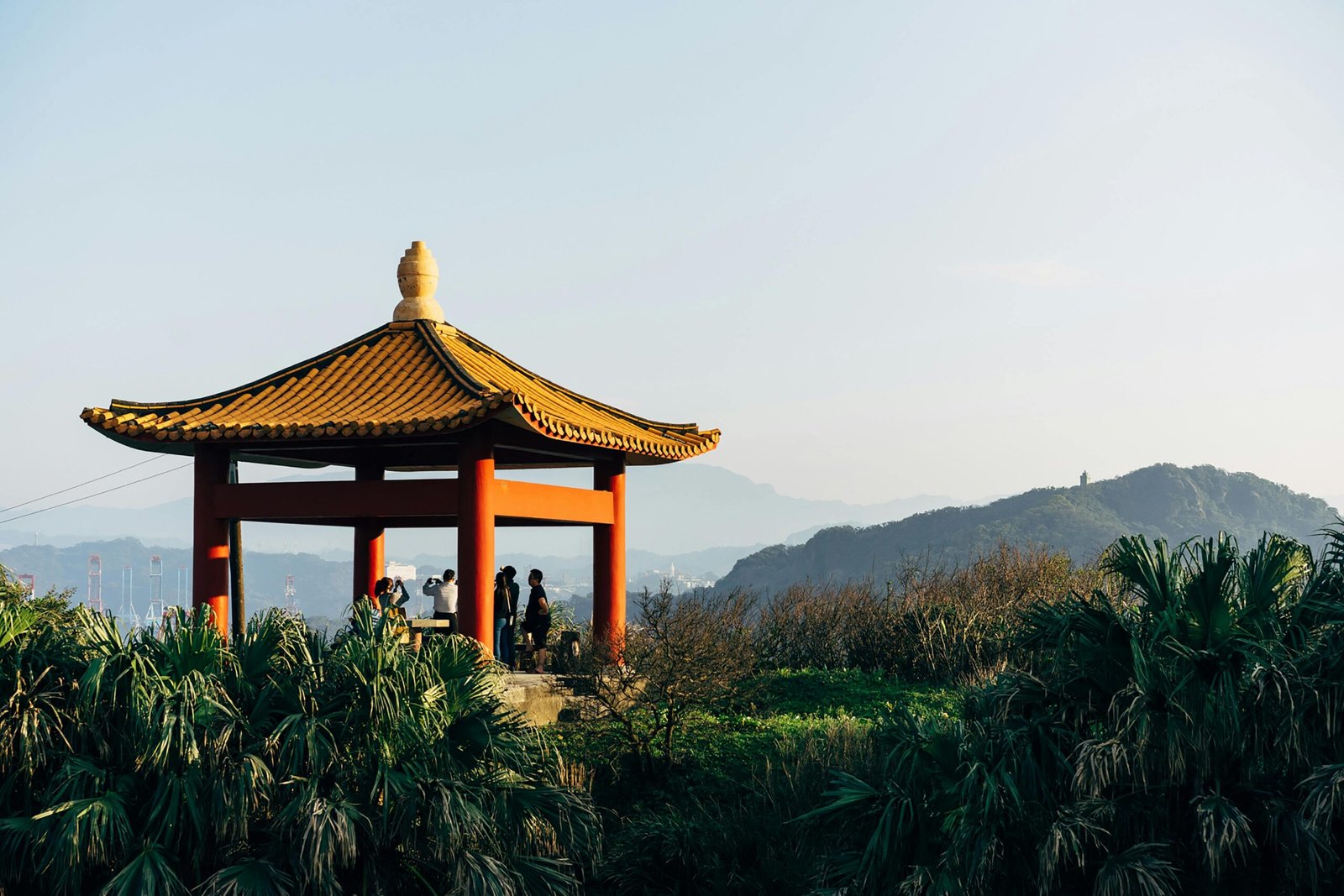 Diverse Taiwan travel image featuring the iconic Taipei 101 skyscraper, modern cityscape, and serene green mountains, highlighting the island's unique blend of urban and natural beauty for 2025 visitors.