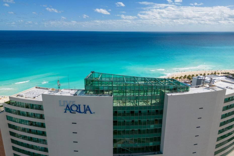 Luxurious all-inclusive resort on a beautiful Cancun beach with turquoise waters, perfect for a dream vacation booked through Costco Travel.