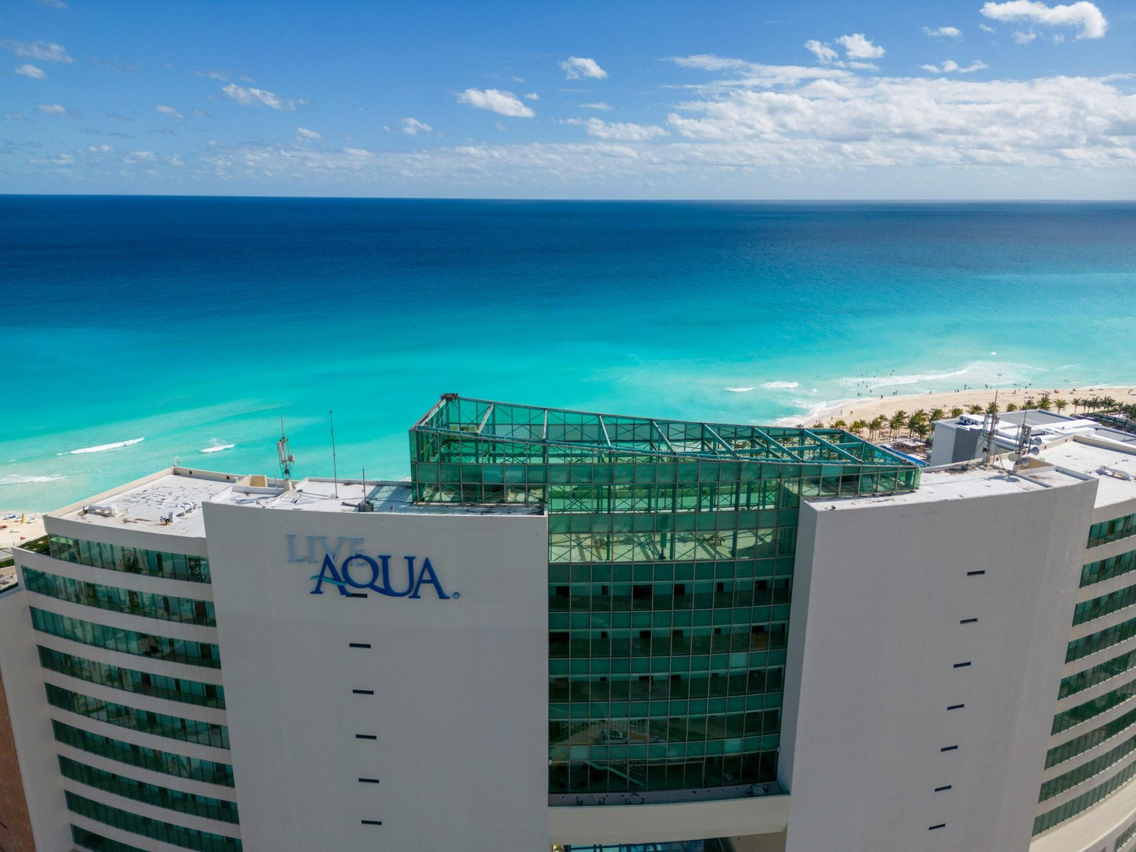 Luxurious all-inclusive resort on a beautiful Cancun beach with turquoise waters, perfect for a dream vacation booked through Costco Travel.