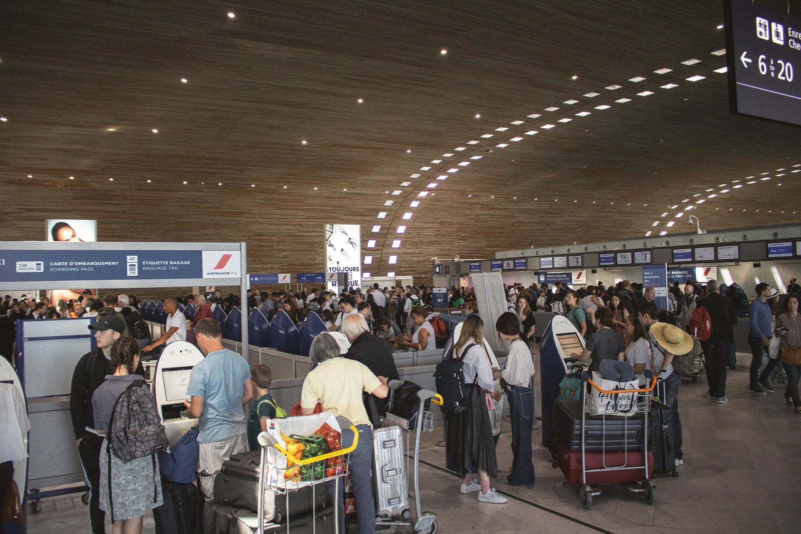 Stressed travelers navigate a crowded MSP Airport terminal during the holiday season, illustrating common flight delays, long security lines, and winter travel challenges.