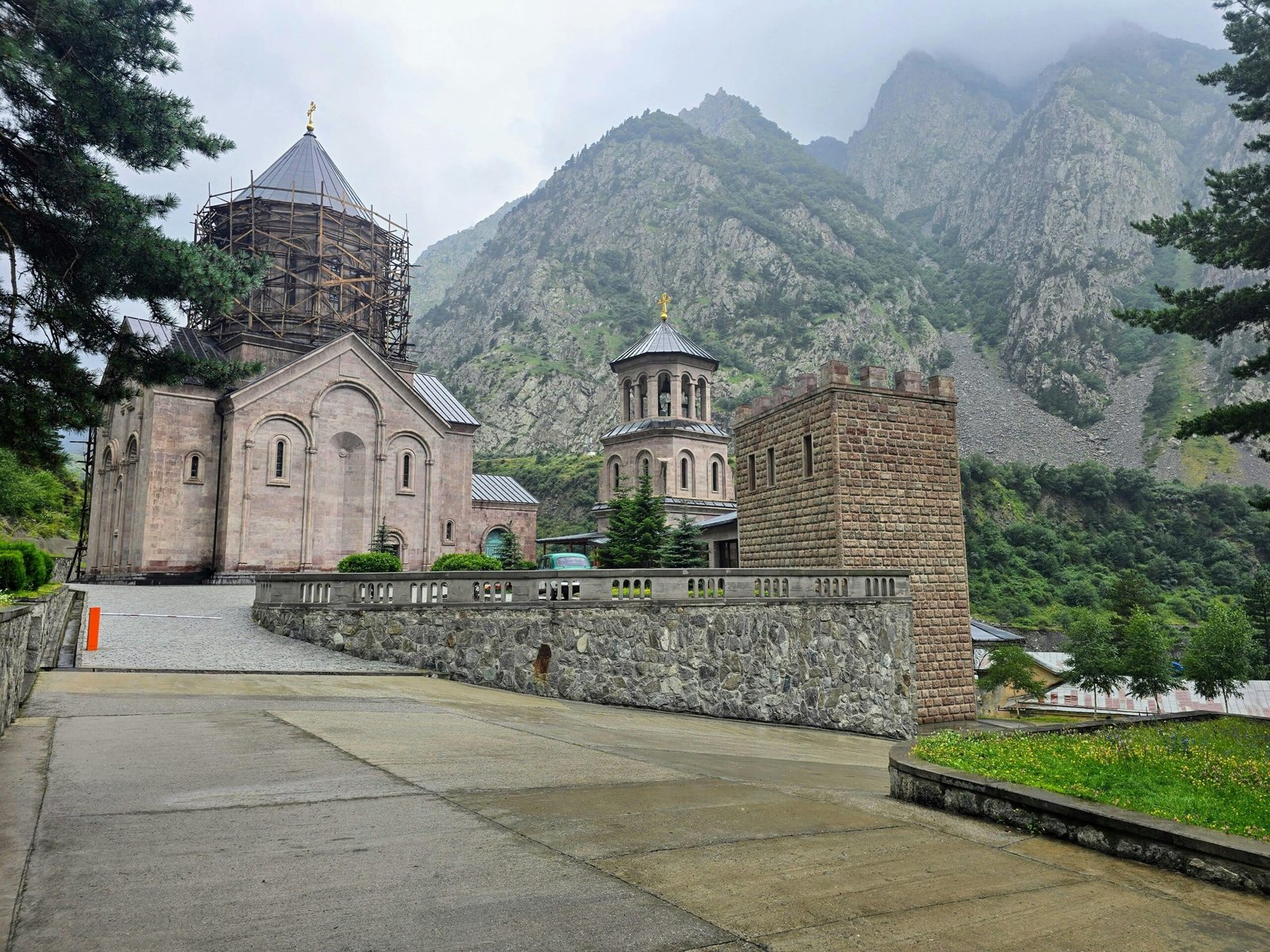 Iconic Gergeti Trinity Church nestled in the majestic Caucasus Mountains, symbolizing the historical and adventurous experiences offered by Georgia travel packages.