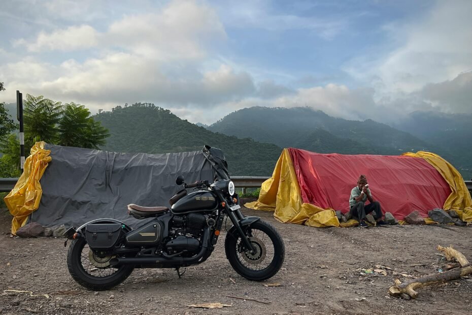 Motorcycle towing compact travel trailer on a scenic road, symbolizing freedom, adventure, and comfortable camping for motorcycle enthusiasts.