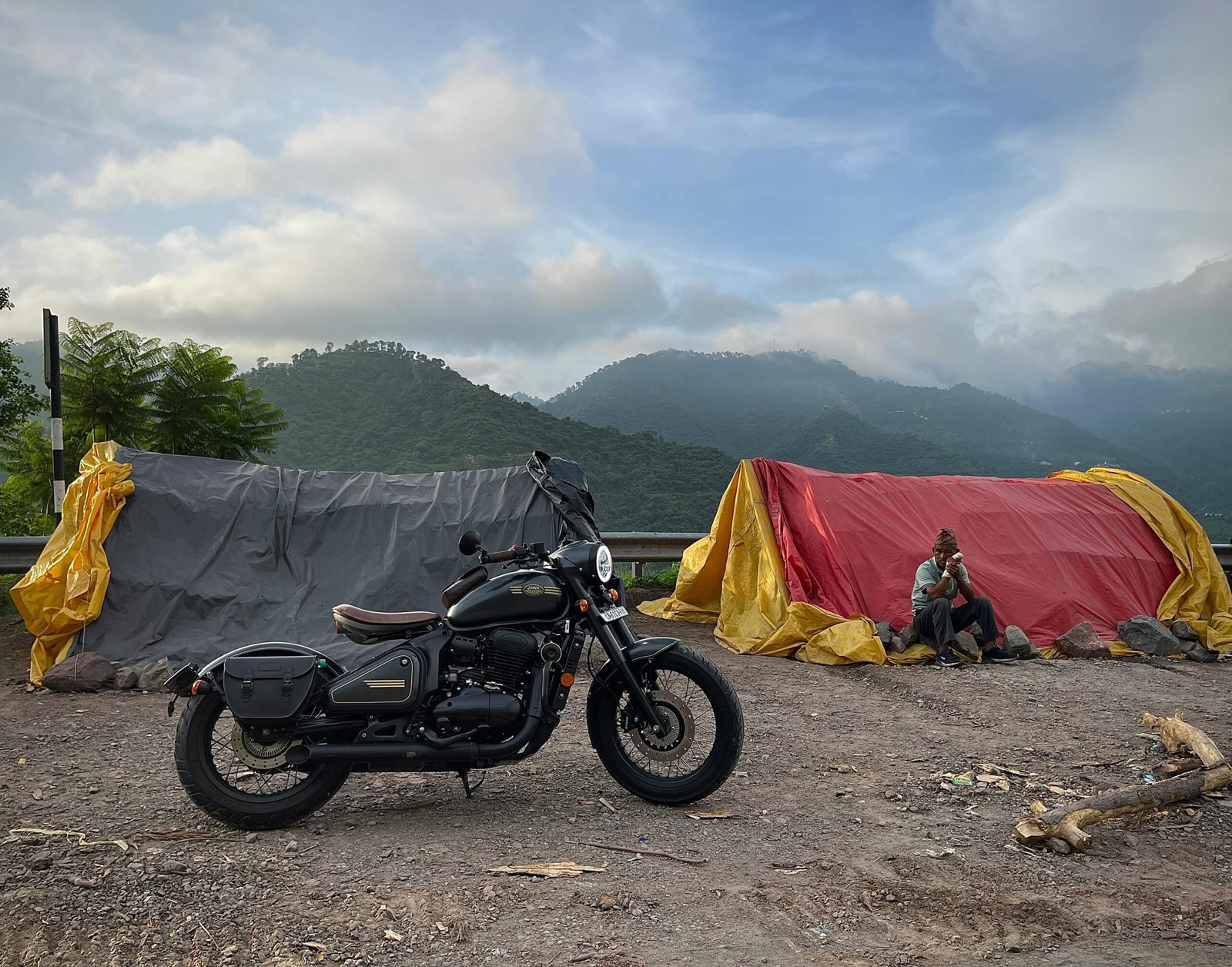 Motorcycle towing compact travel trailer on a scenic road, symbolizing freedom, adventure, and comfortable camping for motorcycle enthusiasts.