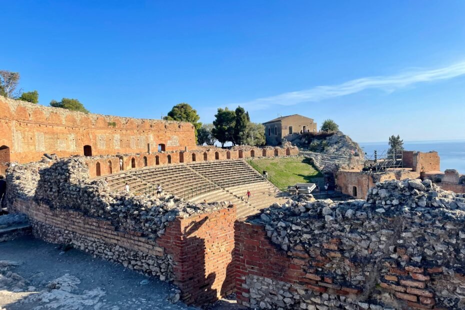 Ancient Greek temple ruins overlooking the picturesque Mediterranean Sea in Sicily, representing the best time to visit this Italian island for ideal weather, cultural exploration, and memorable holidays.