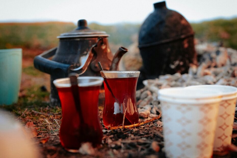 Portable travel tea set with teapot and cups, set in a scenic outdoor location like a mountain vista, ideal for camping, hiking, or enjoying a peaceful tea ritual on any adventure.