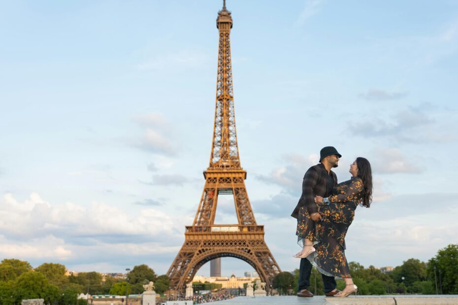 Happy couple enjoying a romantic Paris vacation with Eiffel Tower view, highlighting a stress-free travel tour package.