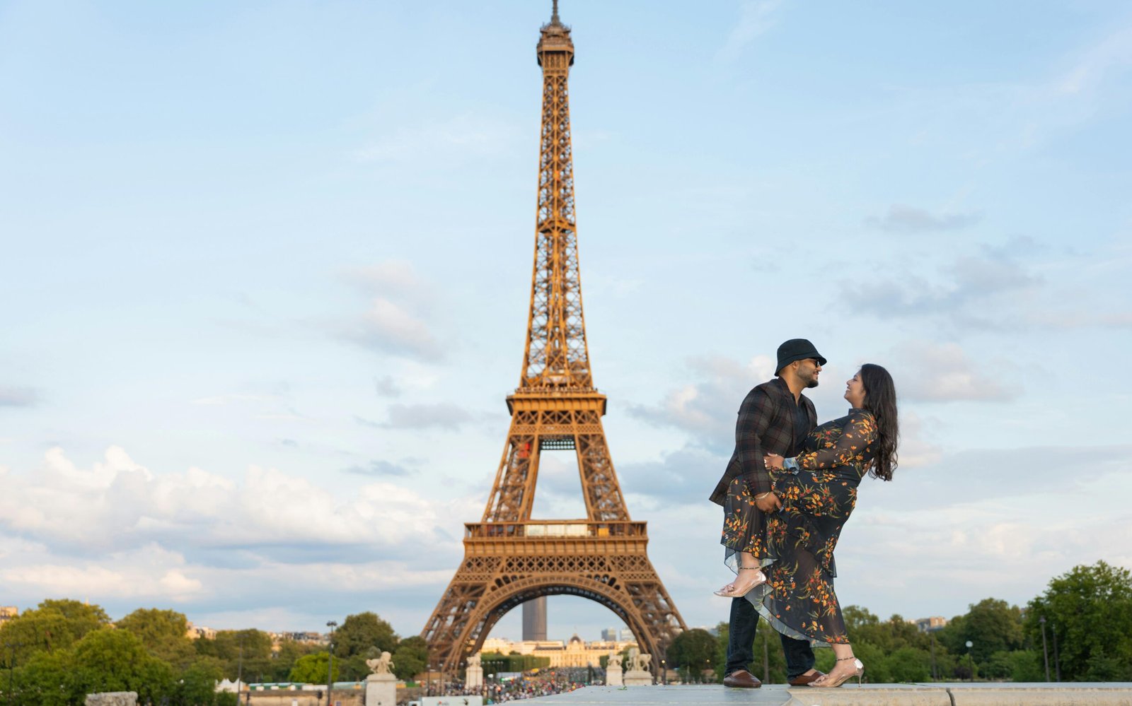 Happy couple enjoying a romantic Paris vacation with Eiffel Tower view, highlighting a stress-free travel tour package.
