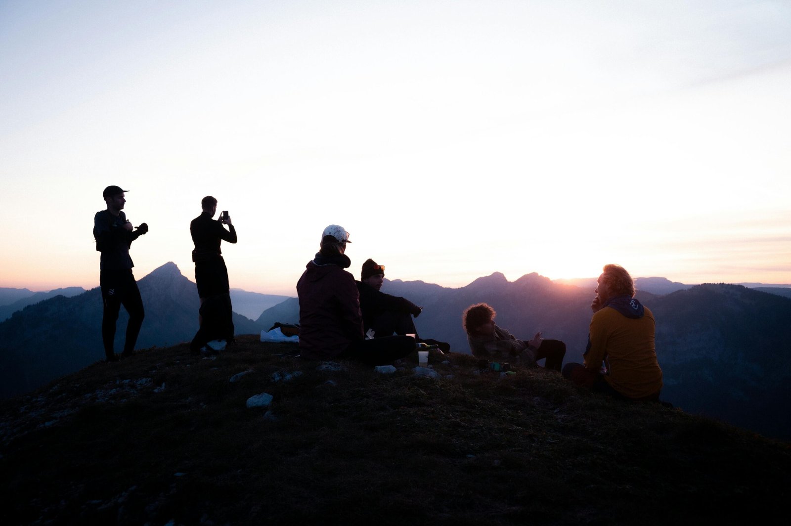 Smiling radiologic technologist with a travel backpack looking towards a vibrant city skyline, embodying the career flexibility and adventure of travel x-ray jobs.