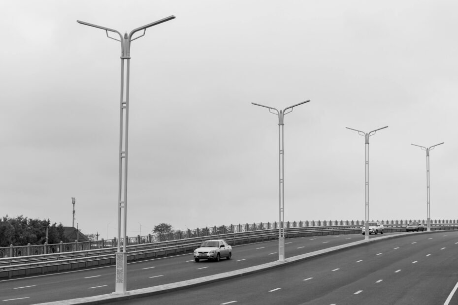 Modern highway travel plaza with gas pumps, commercial trucks, and passenger cars, welcoming travelers to the New Stanton Travel Plaza on the Pennsylvania Turnpike for a convenient break.