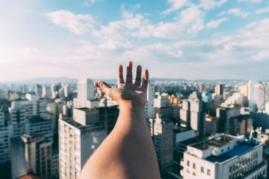 A confident Certified Nursing Assistant (CNA) smiling while looking at a vibrant city skyline, representing the flexibility and adventure of a 4-week travel contract with housing.