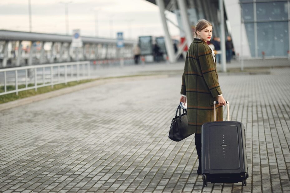 Stylish woman carrying a modern and practical travel tote bag through an airport terminal, perfect for a comfortable and organized journey.