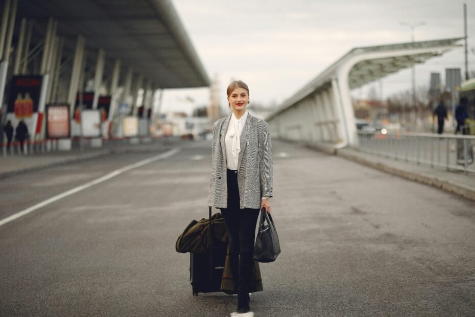 A smiling Licensed Practical Nurse (LPN) standing confidently against a blurred city backdrop, symbolizing the professional growth, adventure, and financial benefits of LPN travel contracts and healthcare careers.