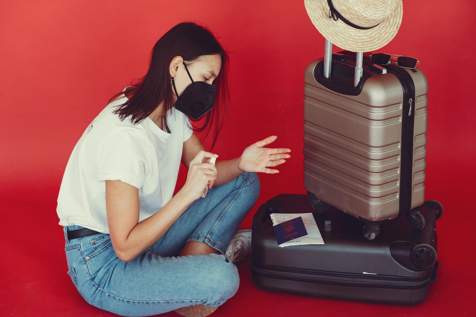 Traveler using a travel size Lysol disinfectant spray to sanitize hotel surfaces, promoting hygiene and peace of mind while traveling.