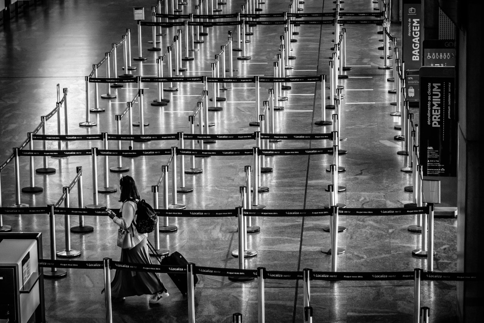 A traveler effortlessly navigating a modern airport with a versatile roller backpack, highlighting the convenience of wheeled luggage for smart and flexible journeys.