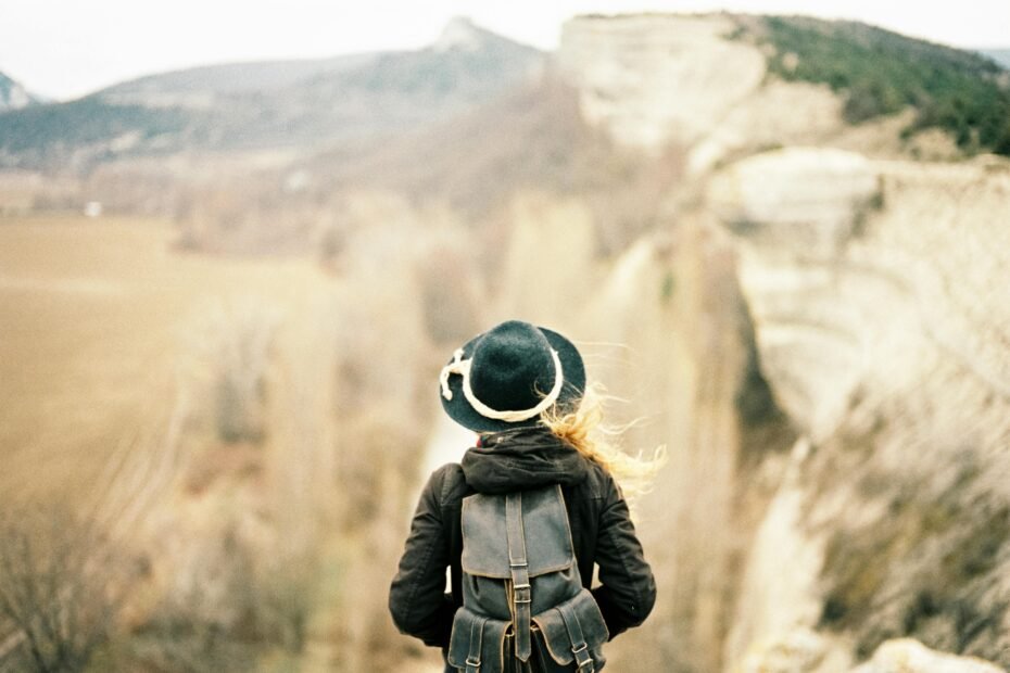 A female traveler wearing a perfectly fitted women's travel backpack, ready for adventure and exploration, highlighting the comfort and design benefits of a backpack specifically for women.