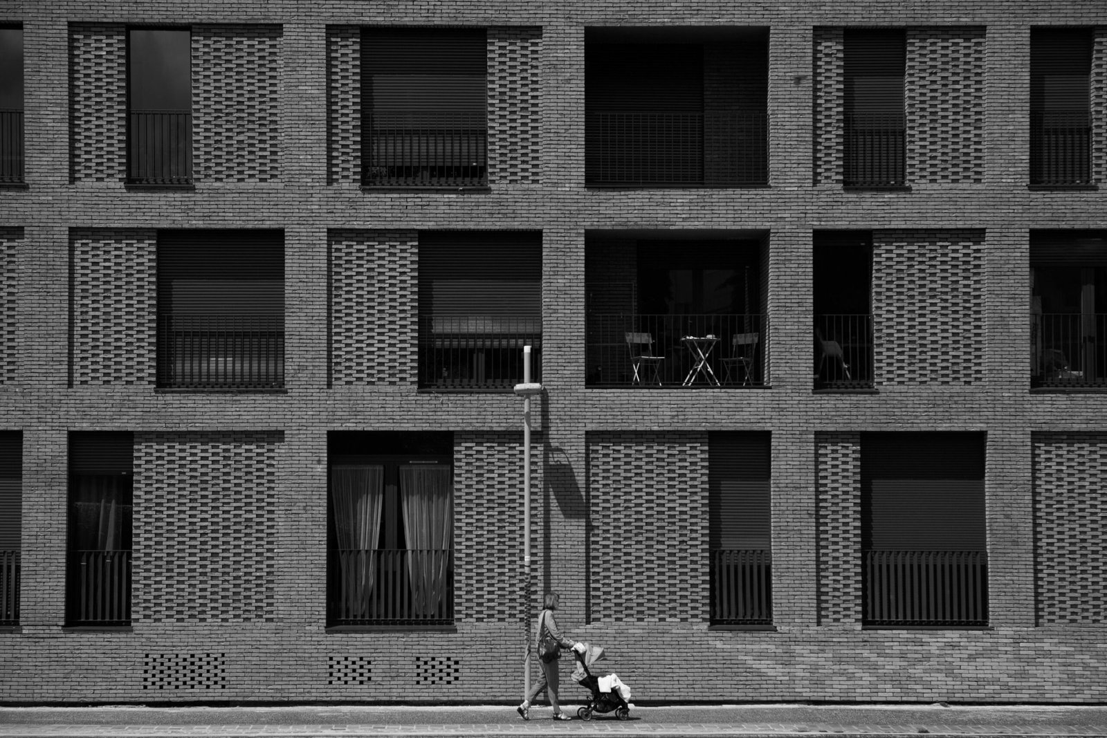 Modern parent pushing a Nuna stroller travel system with an infant car seat, showcasing premium design, safety, and seamless convenience for urban family life.