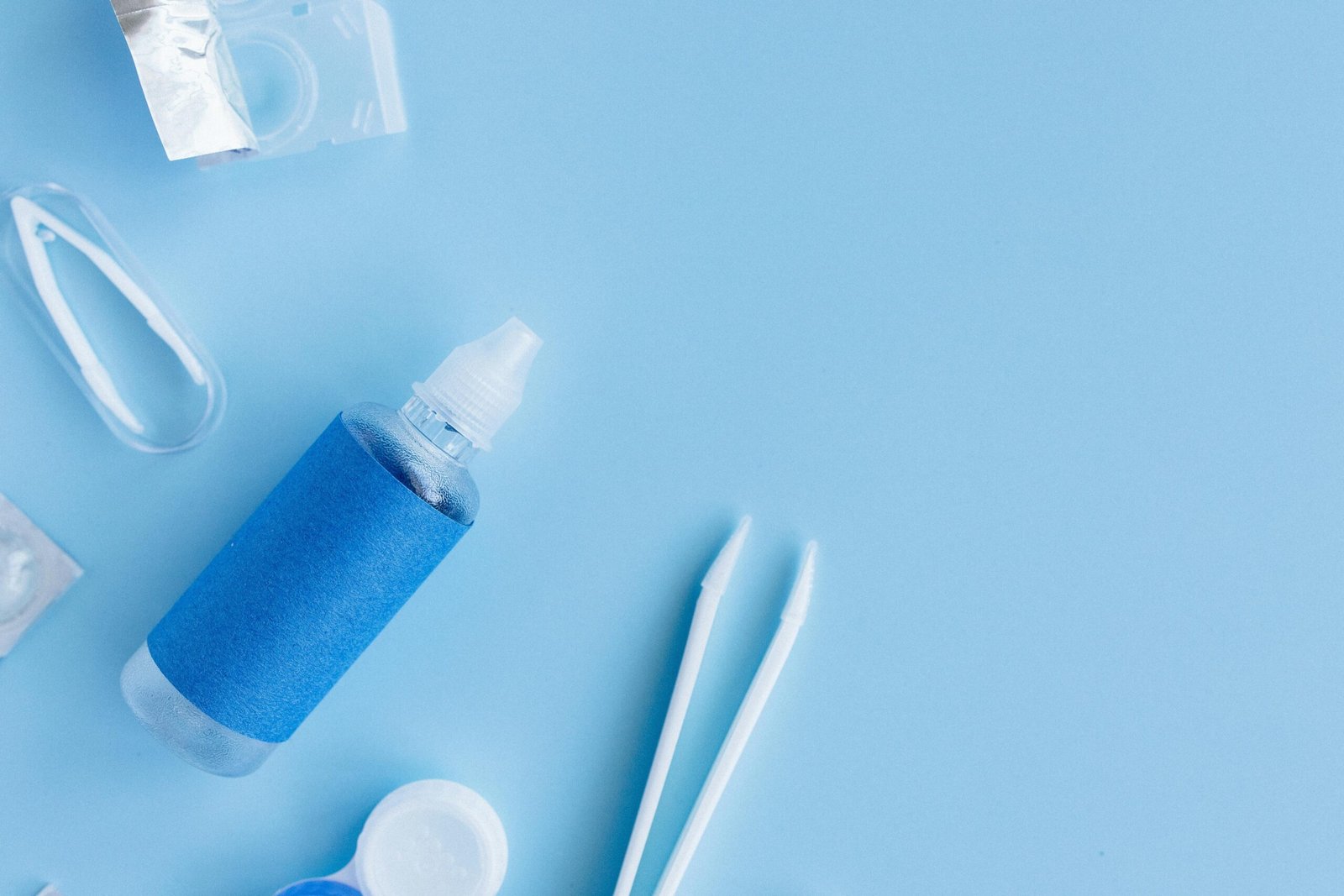 Travel size contact lens solution bottle and case, essential for contact lens wearers, packed for a trip adhering to TSA guidelines for healthy eyes.