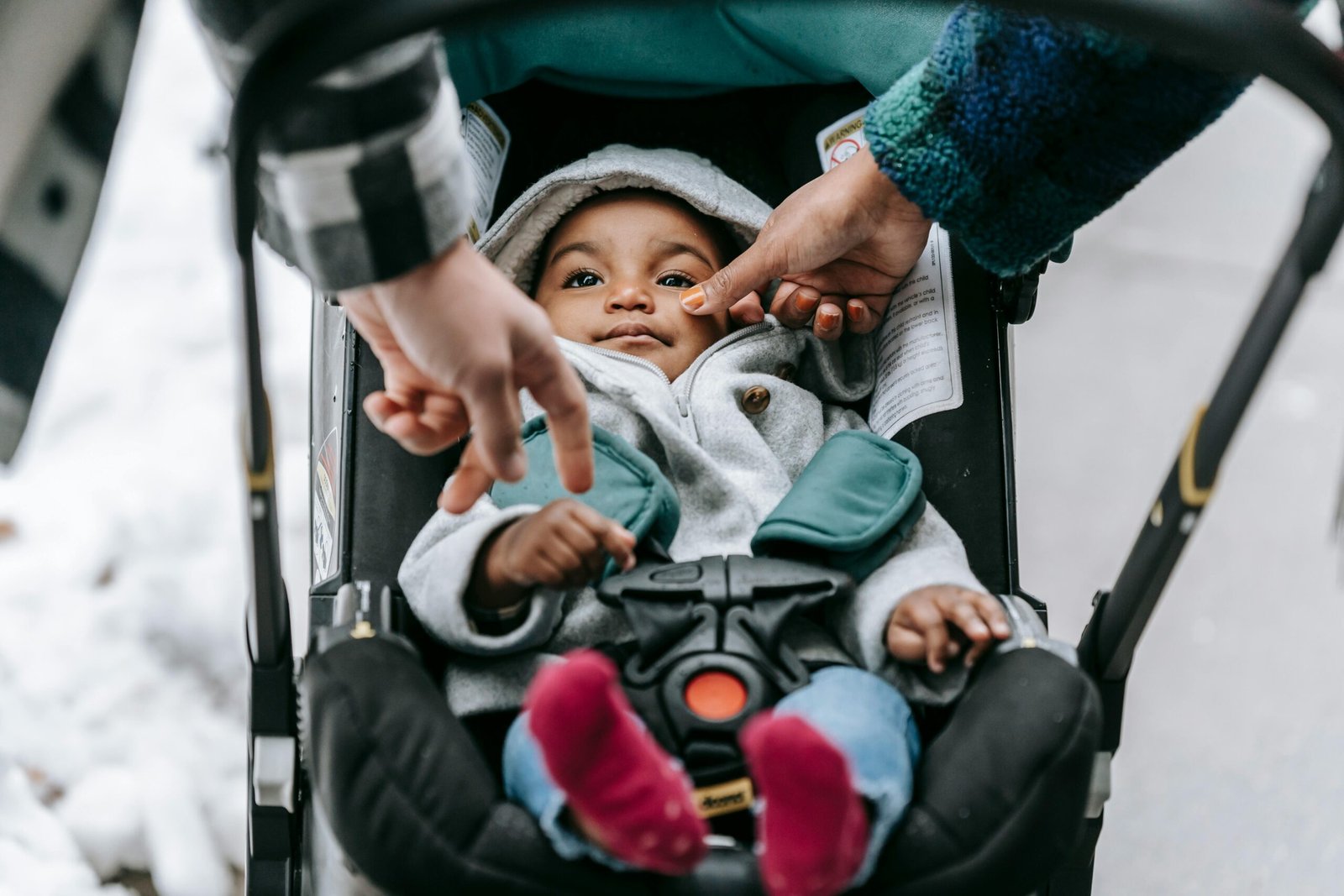 Happy parent pushing a compact travel stroller with baby through an airport terminal, highlighting stress-free airplane travel with the best lightweight stroller for infants and toddlers.