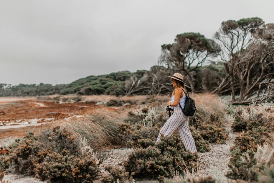 A happy female traveler exploring with an ergonomic travel backpack, showcasing the best travel backpacks for women for comfort and adventure.