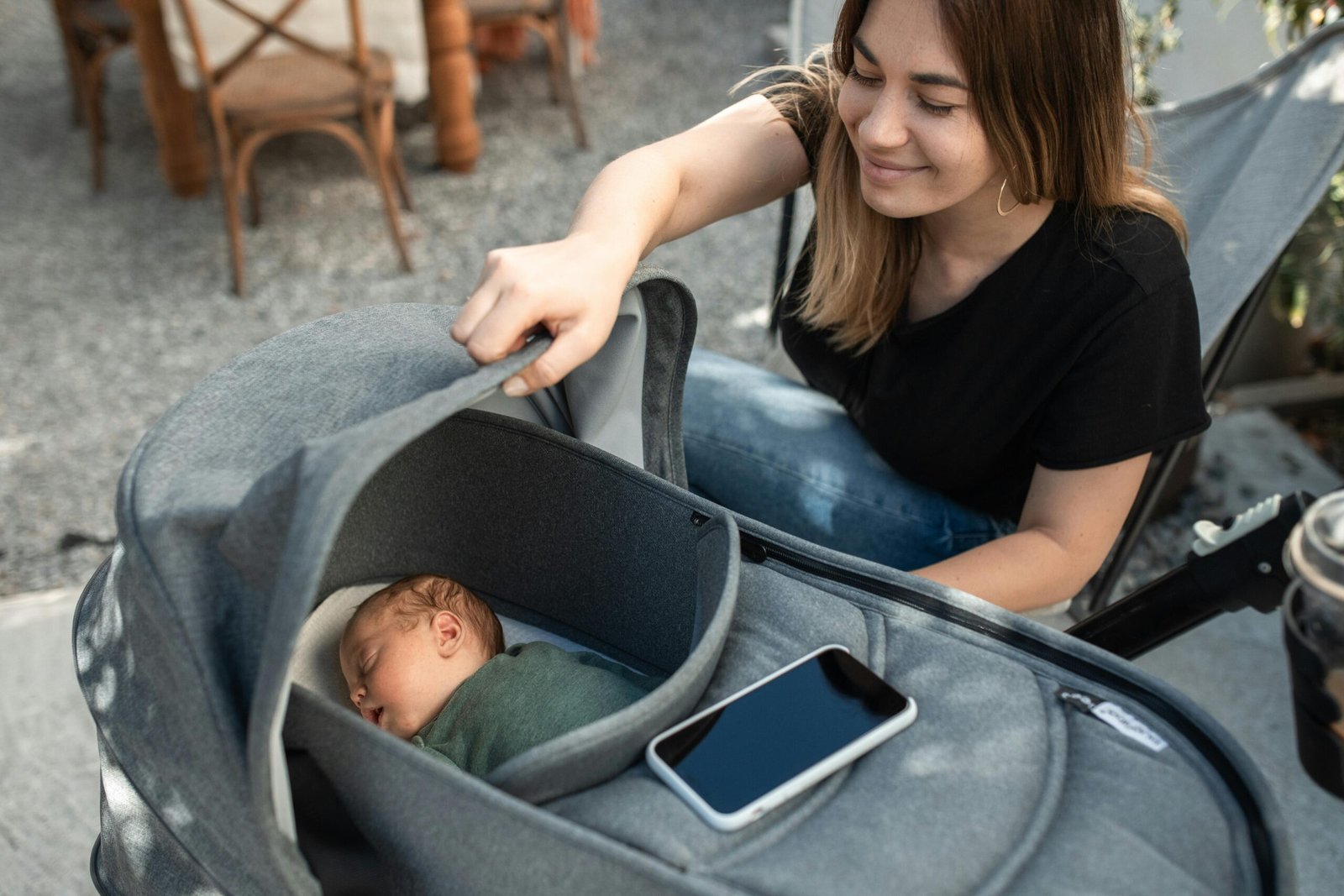 Happy parents effortlessly using a Graco Click Connect travel system, showing an infant car seat securely attached to a stroller for convenient and safe baby transport.