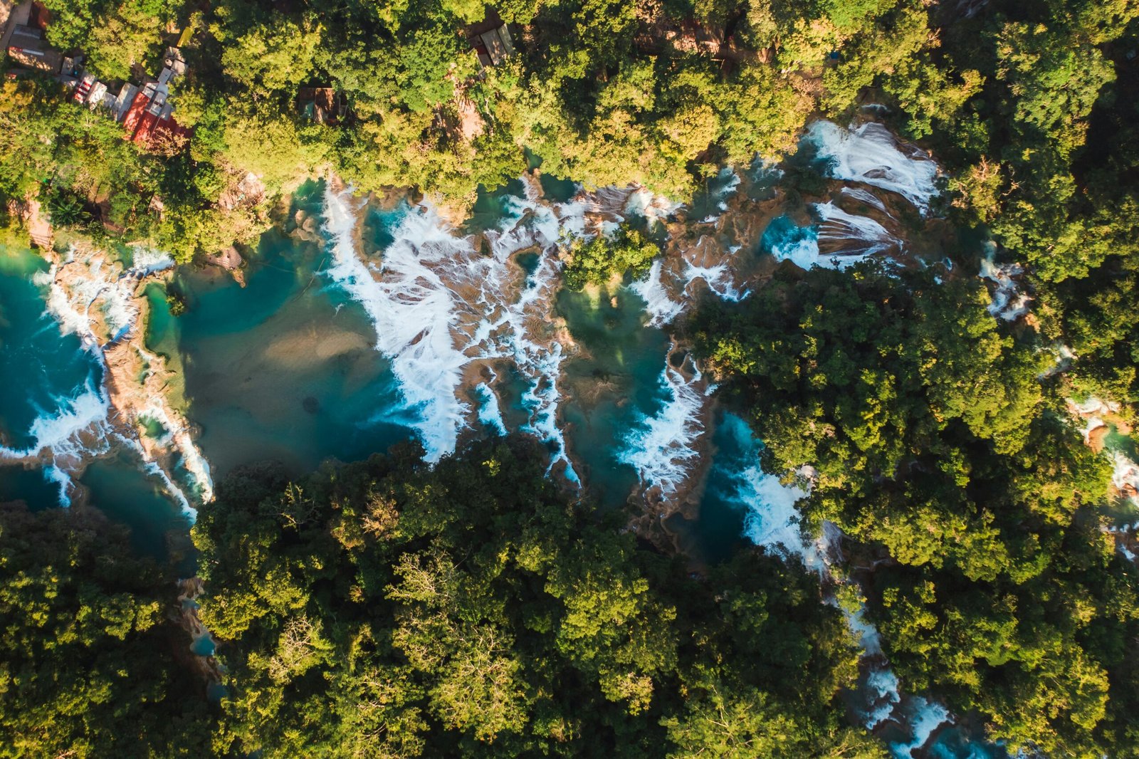 Stunning lush green mountains, a majestic waterfall, and a pristine beach in Kauai, Hawaii, illustrating the best time to visit the 'Garden Isle' for an unforgettable paradise getaway.