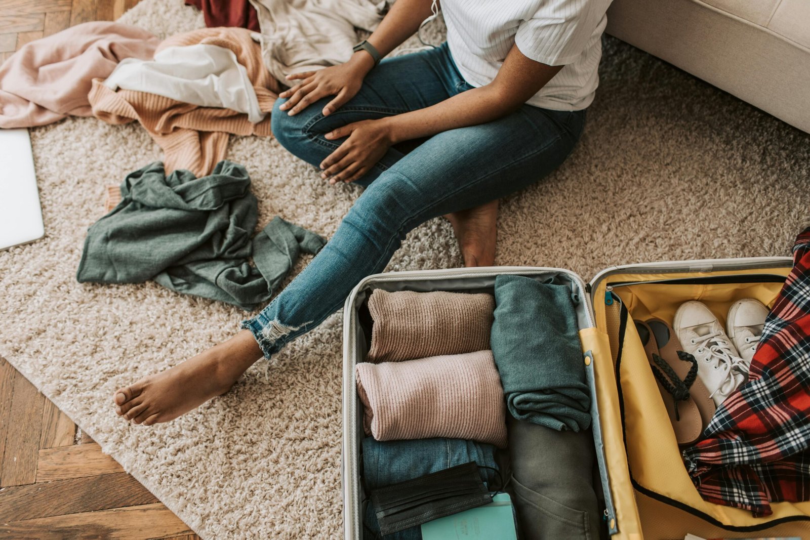 Smart travel hacks for efficient packing and planning, showing organized essentials like rolled clothes, digital documents, and a reusable water bottle for a stress-free journey.