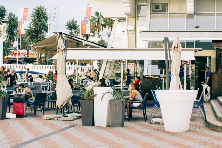 Modern highway travel plaza featuring popular food vendors like Shake Shack and Starbucks, Sunoco gas station, and Taste NY EV charging, designed for New York State Thruway travelers.