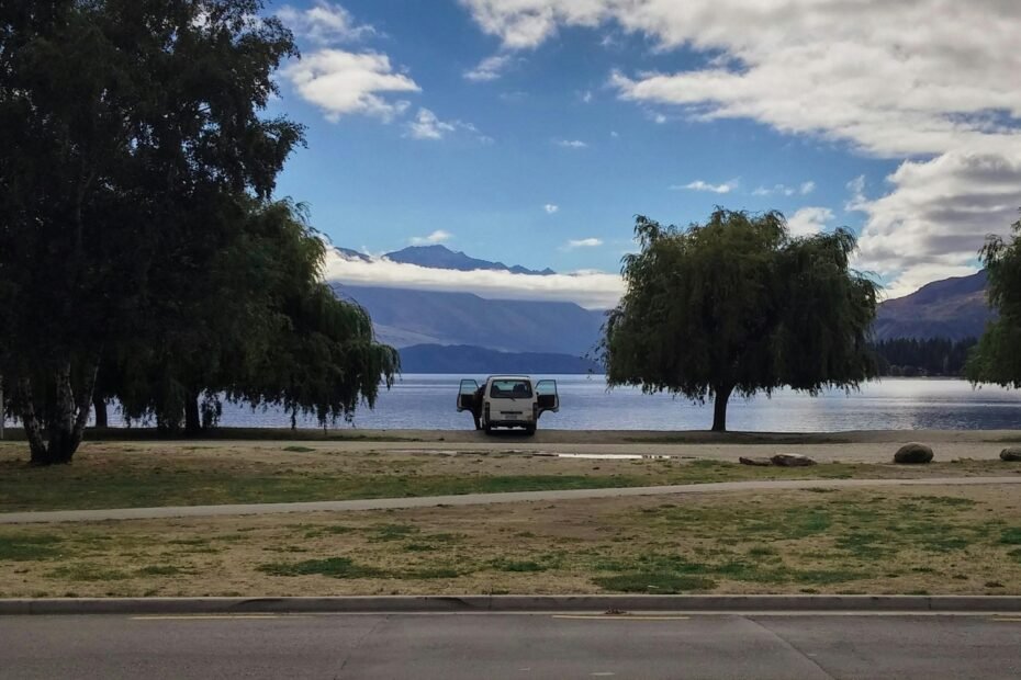 Modern Class B motorhome, also known as a leisure travel van, parked on a scenic mountain road, embodying freedom, luxury, and comfort for those seeking leisure travel vans for sale.